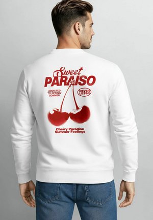 White sweatshirt featuring bold red print on the back, displaying "Sweet Paradise" with cherries and text icons. Adjustable cuffs and neckline.