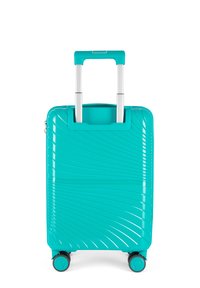 Valigia rigida turchese con una finitura liscia e lucida, dotata di manico estensibile argentato e quattro ruote nere. Motivo a onde testurizzato sulla superficie.