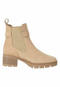 Bottine beige en daim lisse avec des panneaux élastiques sur les côtés et une languette en boucle. Talon épais et texturé pour plus de stabilité.