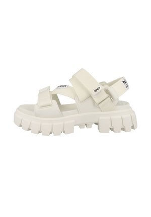 White chunky sandal with thick textured sole, adjustable fabric straps, and "1947" printed on one strap.