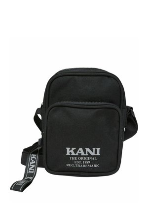 Black nylon crossbody bag with a zippered closure, featuring a front pocket and logo text in white. Adjustable strap included.