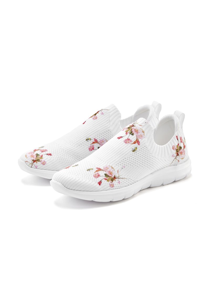White slip-on shoes with textured knit fabric, featuring floral embroidery in pink and green, and a rubber sole for traction.