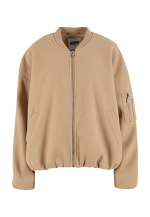 Tan spalvota bomber stiliaus striukė su užtrauktuku priekyje, apvaliu kaklu, šoninėmis kišenėmis ir kišenė su užtrauktuku ant rankovės. Minkšta, tekstūruota medžiaga su laisvu siluetu.