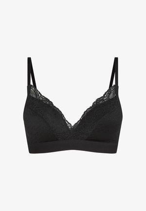 Schwarzer kabelloser BH mit Spitzenbesatz, dünnen verstellbaren Trägern und subtiler gepunkteter Struktur auf den Cups vor weißem Hintergrund.