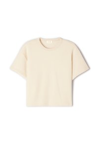 T-shirt beige a maniche corte realizzato in morbido tessuto, con scollatura rotonda e vestibilità rilassata, caratterizzato da una texture sottile e senza motivi visibili.