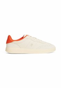 Sneakers w kolorze kremowym z teksturowanym zamszowym wierzchem i pomarańczowymi akcentami na pięcie. Posiadają płaskie sznurowadła oraz niskoprofilową gumową podeszwę.