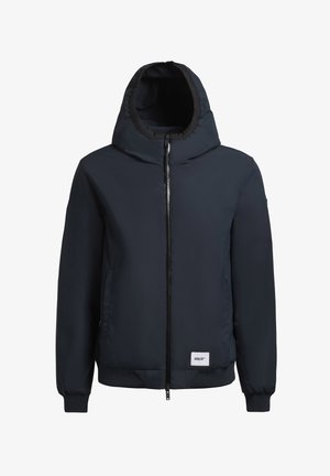 Marineblå polstret jakke med hætte, lynlås foran, ribbede manchetter og kant. Har logo-patch på venstre side. Glat, let materiale.