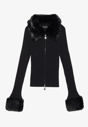 Black ribbed knit jacket with a faux fur collar and cuffs. Features a silver zipper and heart-shaped pull accent. Fitted design.