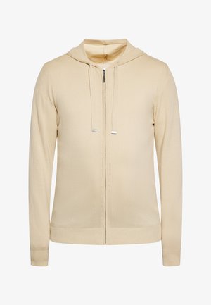 Beige Zip-Hoodie mit taillierter Passform, Kordelzugkapuze, gerippten Bündchen und Saum. Hergestellt aus weichem Strickmaterial mit glatter Textur.