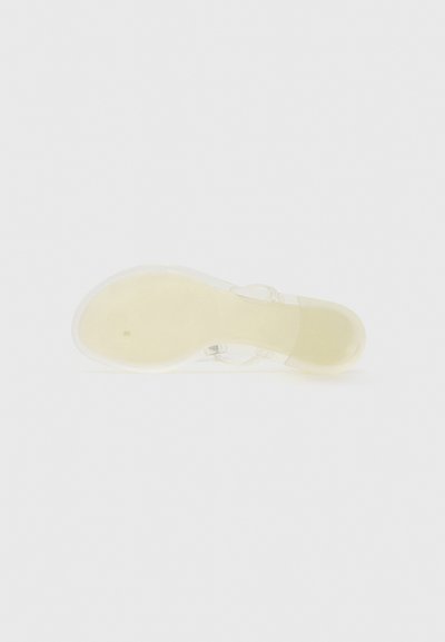 Clear heel sandal with transparent straps and a smooth translucent sole. Features a rounded toe and a sleek, minimal design.