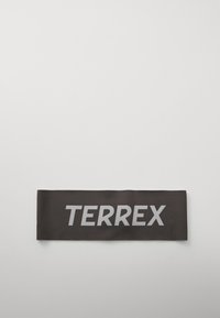 Black fabric band featuring the word "TERREX" in bold, light gray letters, with a smooth texture and rectangular shape.