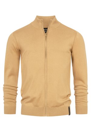 Tanan zip-up kardigan s visokim ovratnikom, rebrastim manžetama i obrubom. Glatko, lagano pletivo s minimalnim detaljima.