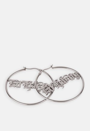 Silver hoop earrings with a Gothic script design hanging within the circles, featuring a polished metal finish and a smooth texture.