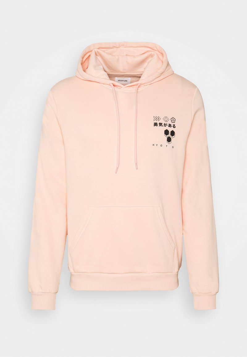 Hoddy rosa chiaro realizzato in morbido tessuto, con tasca frontale, coulisse e grafiche nere sul petto, tra cui testo e forme geometriche.