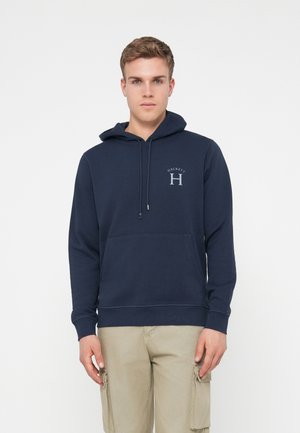 Navy blue hoodie with attached drawstring, front pocket, and light gray logo. Soft cotton fabric with ribbed cuffs and hem.