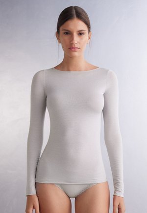 Light gray long-sleeve top with a smooth texture, scoop neckline, and fitted design. Paired with white lace-trimmed bottom.