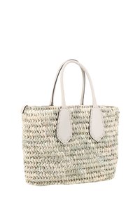 Woven straw tote bag in light cream with pale green accents, features two leather handles and decorative stitched detailing on the sides.