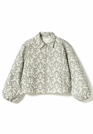 Quilted jacket with a high collar, light cream fabric featuring dark floral pattern, front zipper, and voluminous sleeves.
