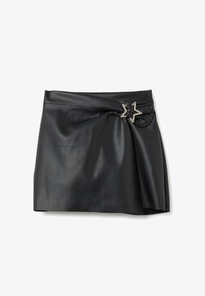 Schwarzer Kunstleder-Minirock mit einer gerafften Detail auf der linken Seite, gesichert durch eine mit Strass besetzte, sternförmige Schnalle.