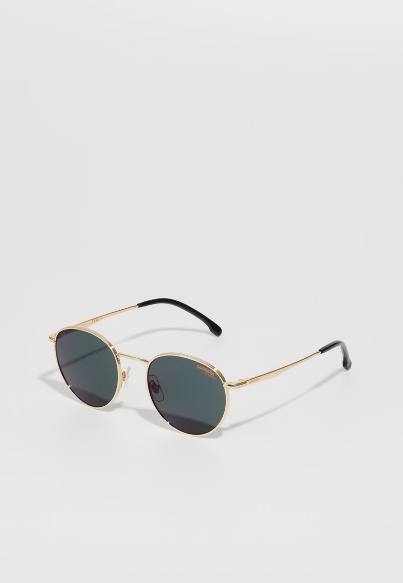 Occhiali da sole in metallo dorato con lenti verde scuro, di forma rotonda, con steli sottili e punte nere. Presentano il logo del brand sulla lente superiore.