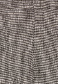 Gray patterned fabric with a textured weave; features subtle lines in darker shades. Suitable for trousers with a tailored design.