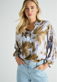 Lichtblauw button-up shirt met bruine bloemmotieven, gemaakt van een gladde stof. Heeft een relaxte pasvorm en opgerolde lange mouwen.
