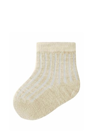 Chaussette bébé beige avec texture côtelée et rayures verticales bleu clair, conçue pour les nourrissons.