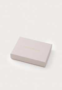 Rectangular pink box made of paper, featuring a gold "COCCINELLE" logo embossed on the top. Smooth texture, minimalist design.