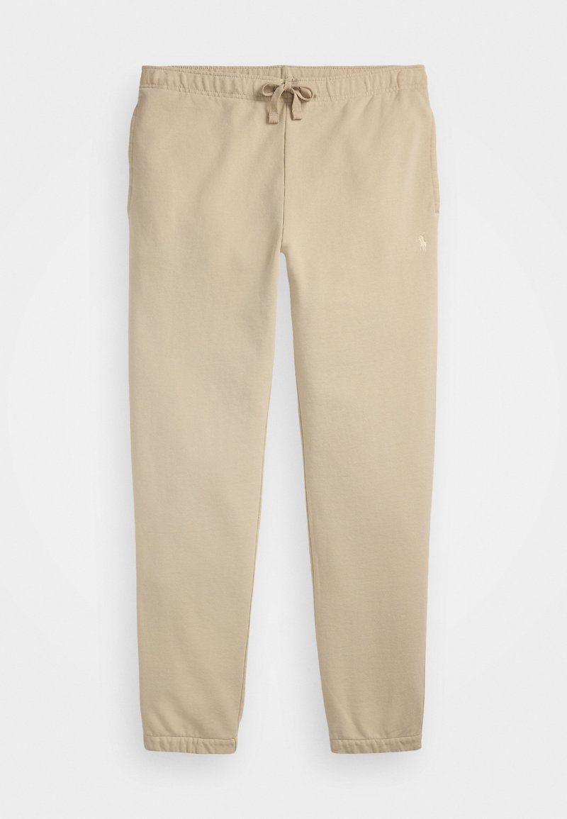 Beige sweatpants med elastisk midje, snøring og mansjetterte ankler. Har en liten logo på øvre venstre ben. Myk stofftekstur.