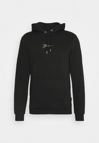 Sudadera negra de algodón, con un bolsillo canguro, cordones con puntas de metal dorado y un logotipo minimalista dorado en el pecho.
