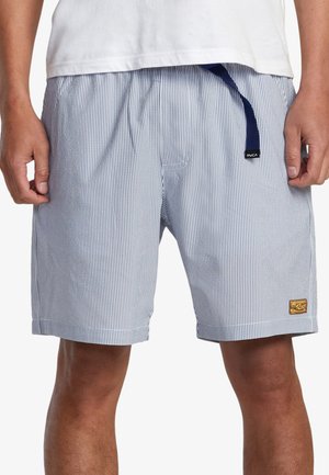 Striped swim trunks in navy and white. Features elastic waistband with drawstring and a gold-tone logo patch on the side.