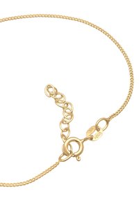 Collier en or avec un design torsadé, un fermoir en forme de homard et une longueur ajustable grâce à des maillons supplémentaires pour varier la taille.