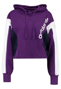 Felpa corta viola con dettagli in bianco e blu navy. Presenta cordini, polsini a costine e un logo stampato sul davanti. Tessuto morbido.