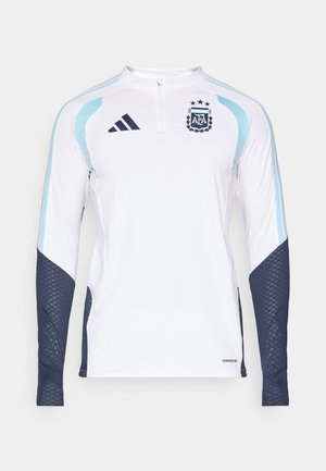 Pitkähihainen jalkapallopaita valkoisena, jossa on vaaleansinisiä ja tummansinisiä yksityiskohtia. Sisältää vetoketju-aukko, verkkokankaat hihoissa ja AFA-logon.