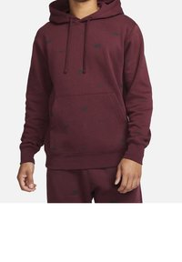 Burgundy hooded sweatshirt featuring a kangaroo pocket, subtle black logo pattern, ribbed cuffs, and hem in a soft, textured fabric.