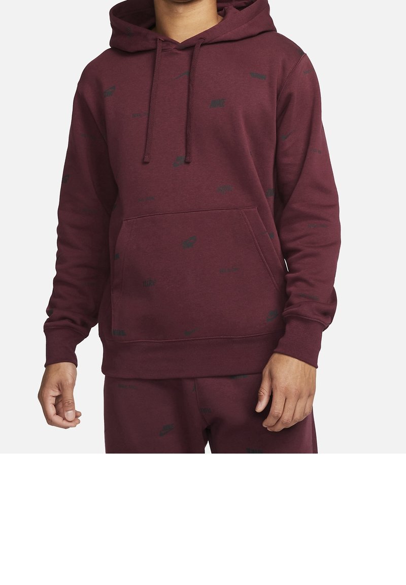 Burgundy hooded sweatshirt featuring a kangaroo pocket, subtle black logo pattern, ribbed cuffs, and hem in a soft, textured fabric.