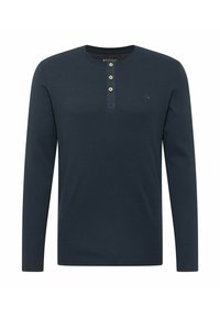 Marineblå langærmet skjorte lavet af blødt stof med rund halsudskæring, tre-knaps lukning og lille logo på brystet.