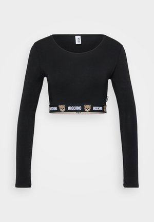 Black long-sleeve cropped top with round neckline, featuring Moschino logo and teddy bear icons on the bottom hem band.