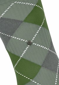 Zielone skarpetki w romby z teksturowanym splotem w różnych odcieniach zieleni i szarości, zdobione białymi konturami diamentów oraz okrągłym guzikiem z logo.