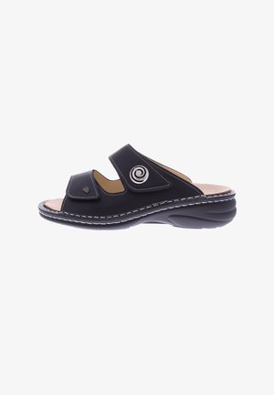 Black leather sandal with two adjustable straps, a spiral accent, and a cushioned footbed. Features a rounded, textured sole for comfort.