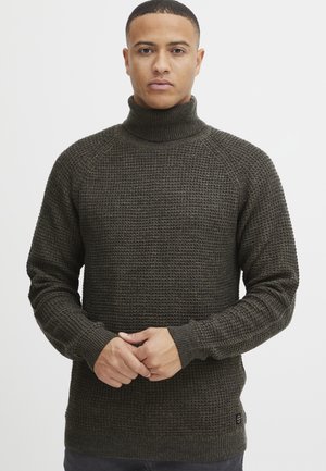 Dunkelgrüner Strick-Turtleneck-Pullover mit einem strukturierten Waffelmuster. Verfügt über gerippte Ärmelbündchen und Saum sowie ein kleines Logo-Detail am unteren Rand.