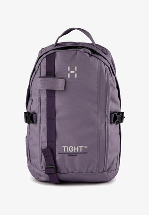 Lila kompakter Rucksack mit Tragegriff oben, verstellbaren Gurten, vorderem vertikalem Riemen und "TIGHT™ X SMALL"-Markierung auf der Frontseite.