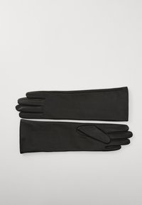 Lange, sorte latexhandsker med en glat tekstur og tætsiddende design, der har forlængede manchetter og en sømløs finish.
