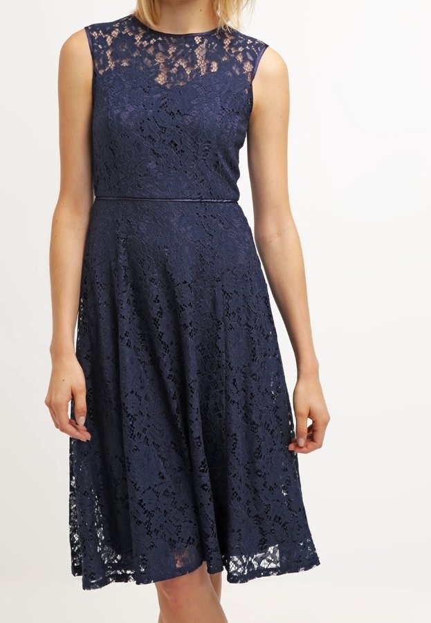 Navy blue lace dress with a fitted bodice and flared skirt, featuring a sleeveless design and lace overlay with floral patterns.