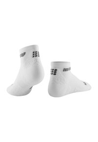 White ankle socks with textured patterns, a ribbed top edge, and black logo accents. Constructed from a breathable, stretchy material.