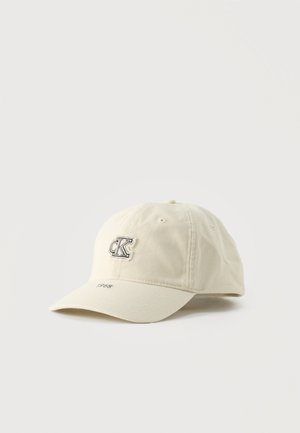 Beige baseball cap with "CK" logo patch on front and "1968" embroidered on the brim, displayed on a plain light background.