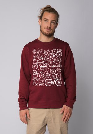 Bordeauxfarbener Pullover mit einem weißen Fahrradgrafikmuster auf der Vorderseite. Aus weichem Stoff, mit langen Ärmeln und Rundhalsausschnitt.