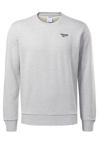 Szara bluza z okrągłym dekoltem wykonana z bawełnianej mieszanki, z prążkowanymi mankietami i dołem, z małym logo Reebok na górnej lewej stronie klatki piersiowej.