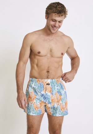 Men's swim shorts with an elastic waistband, featuring a vibrant leaf pattern in blue, green, and orange on a white background.