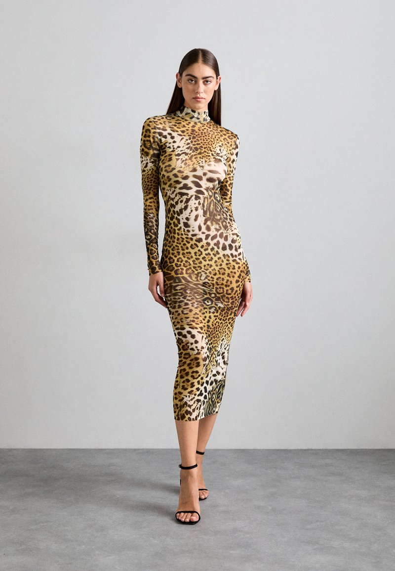 Long-sleeve, form-fitting dress in leopard print, featuring a high neck and smooth texture. Complemented with black strappy heels.